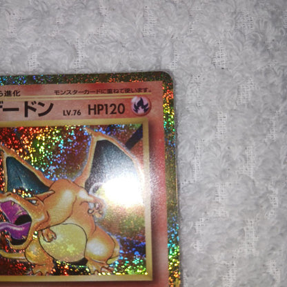 Classic Pokemon Charizard card with clean surface and small chip on upper right corner of the back