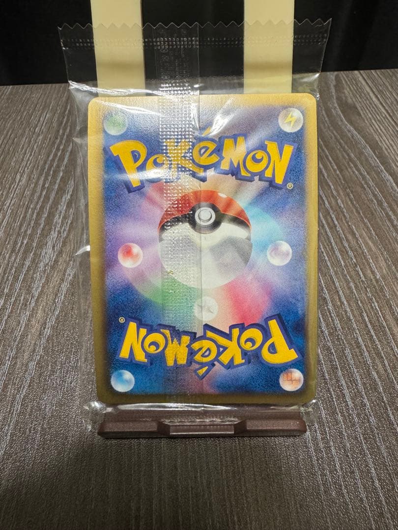 Unopened Pokemon Rekuza P Nobunaga's Ambition First Edition promotional card inside deck case with slight wrinkles on outer bag