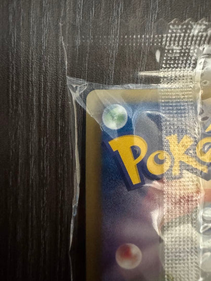 Unopened Pokemon Rekuza P Nobunaga's Ambition First Edition promotional card inside deck case with slight wrinkles on outer bag