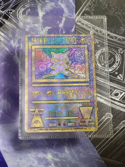 Nintendo Pokemon Ancient Mew first edition card with accompanying movie pamphlet showing wear and stains