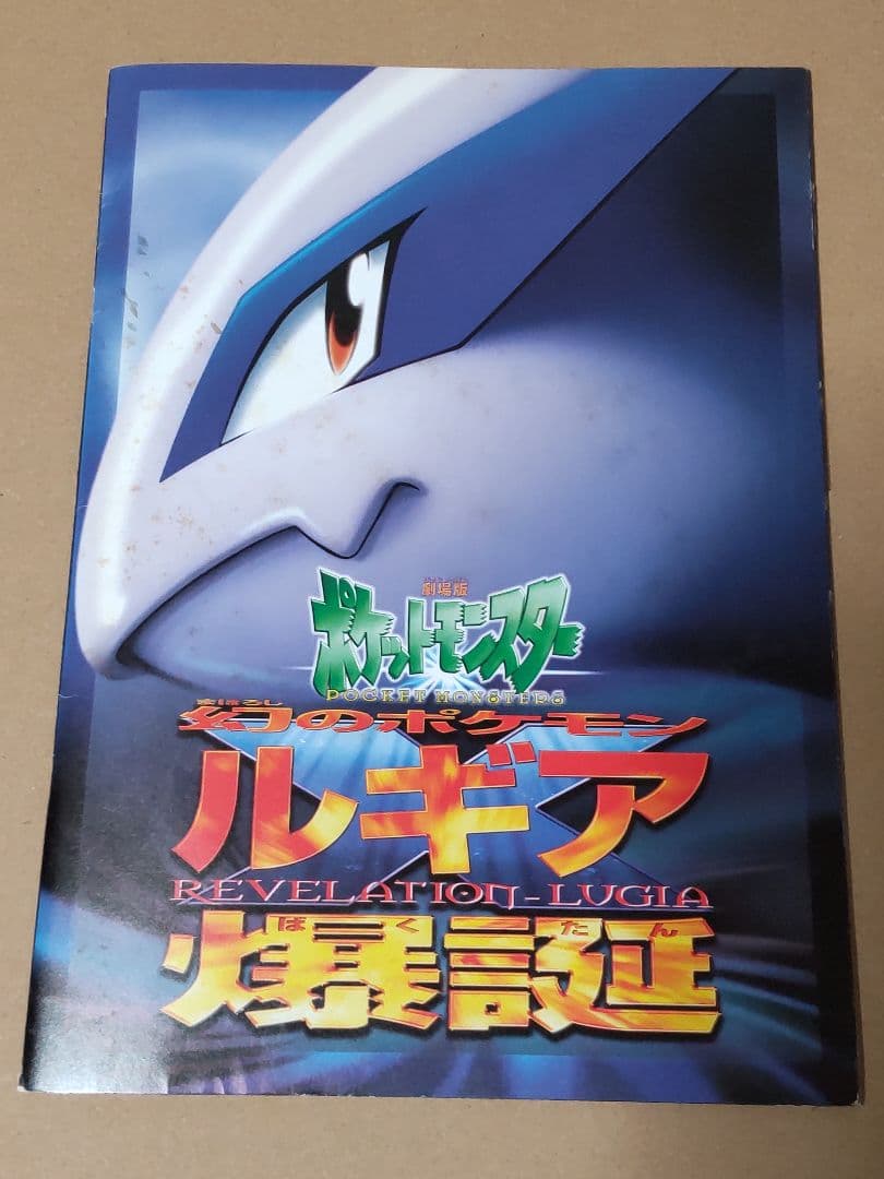 Nintendo Pokemon Ancient Mew first edition card with accompanying movie pamphlet showing wear and stains