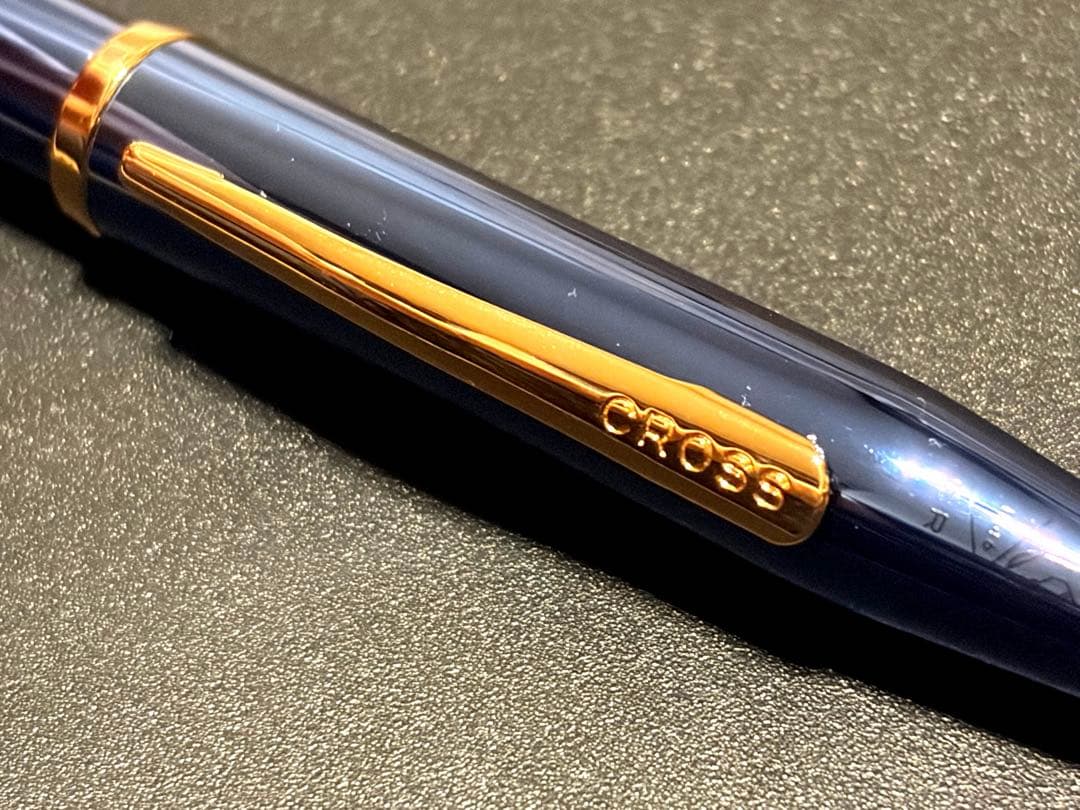 Cross Century II ballpoint pen with navy blue body and gold accents on a white background