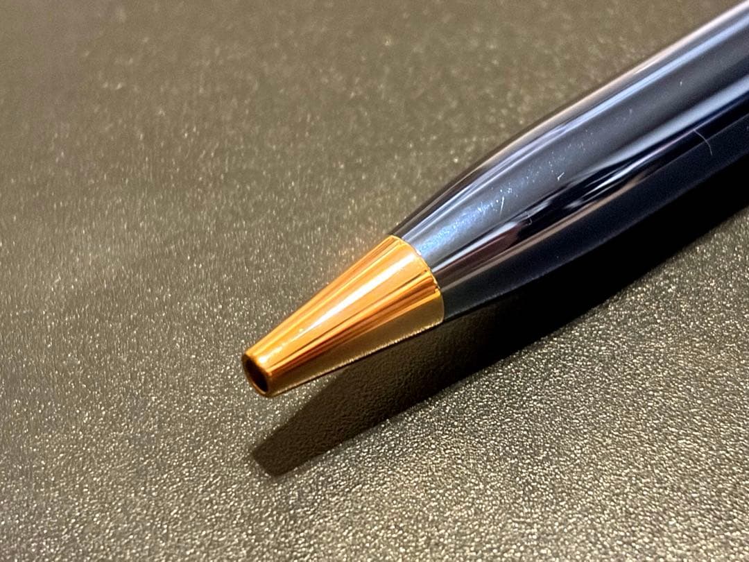 Cross Century II ballpoint pen with navy blue body and gold accents on a white background