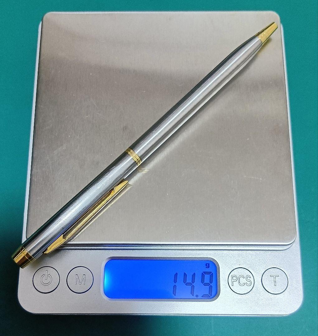Used Unknown Brand twist ballpoint pen with silver and gold two-tone metal body and red CROSS refill