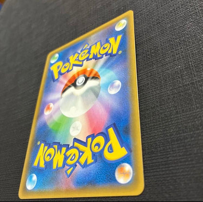 Bandai Pokemon Card Ultra Shiny Requaza GX SSR displayed with protective sleeve