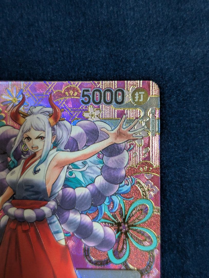One Piece Card Game Yamato SP OP01-121 Parallel card with faint line scratch on back, shown in protective sleeve