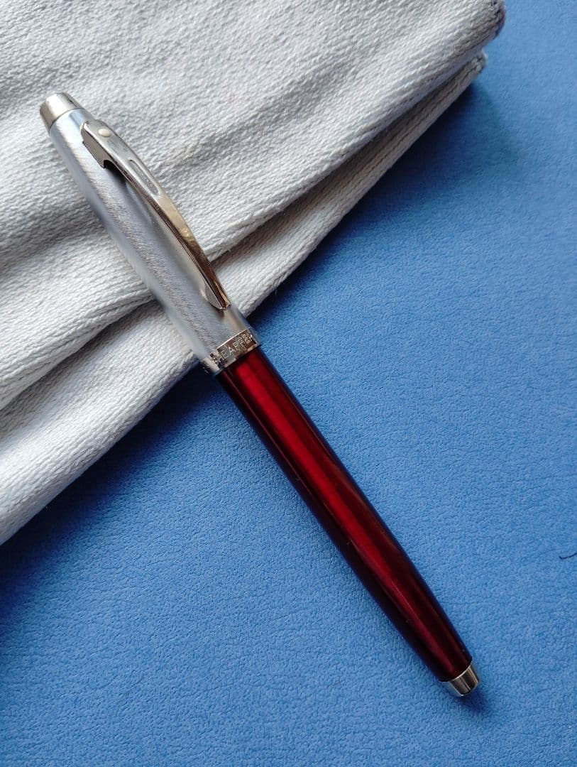 Sheaffer 100 Year fountain pen with red body, silver hairline stainless steel cap, white dot clip, and F nib