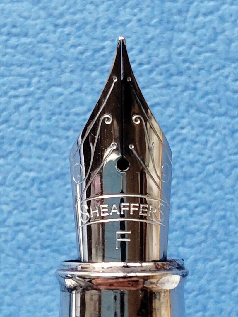Sheaffer 100 Year fountain pen with red body, silver hairline stainless steel cap, white dot clip, and F nib