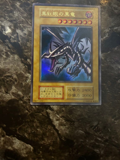 Yugi-Oh Early Ultra Rare Red Eyes Black Dragon playing card from OCG with minor wear and scratches