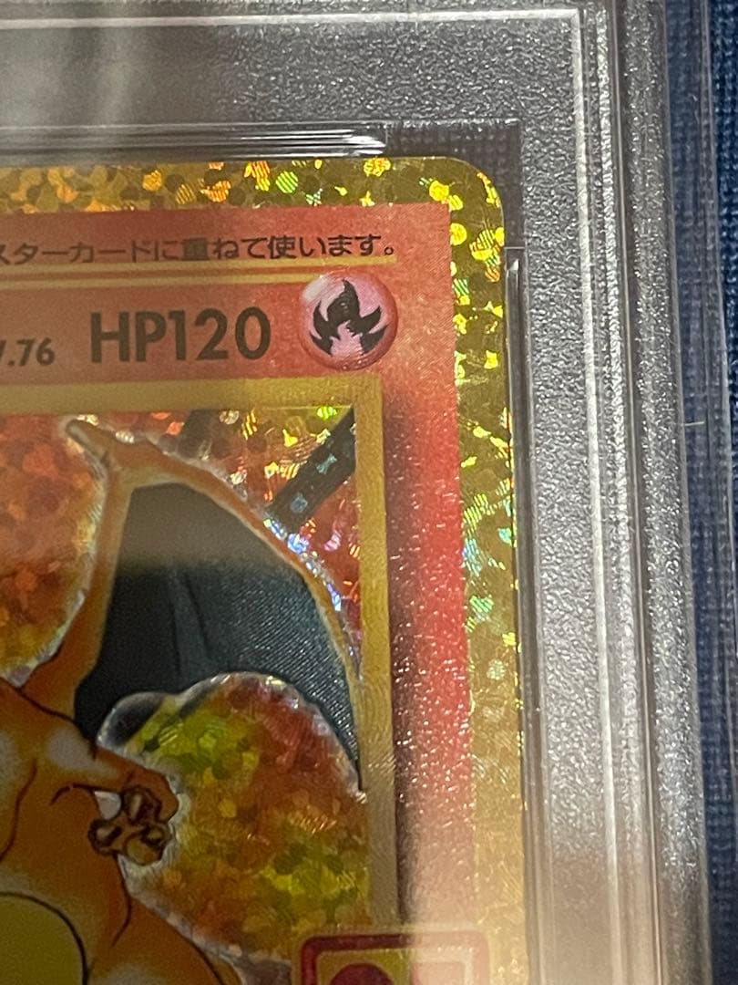 Pokemon 25th Anniversary Charizard collectible card graded PSA 10 with slight imperfections visible