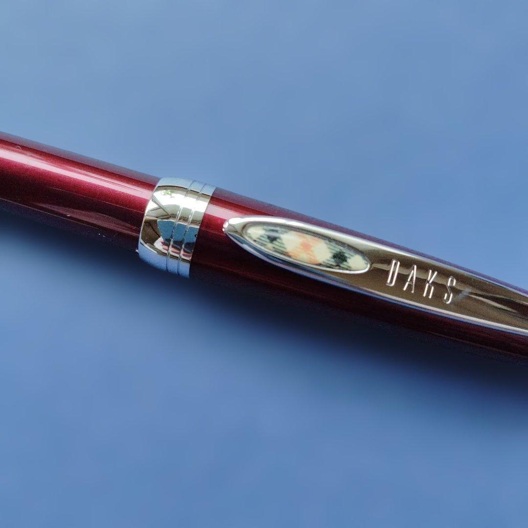 DAKS red ballpoint pen with silver clip and cap on white background metal body Japanese import