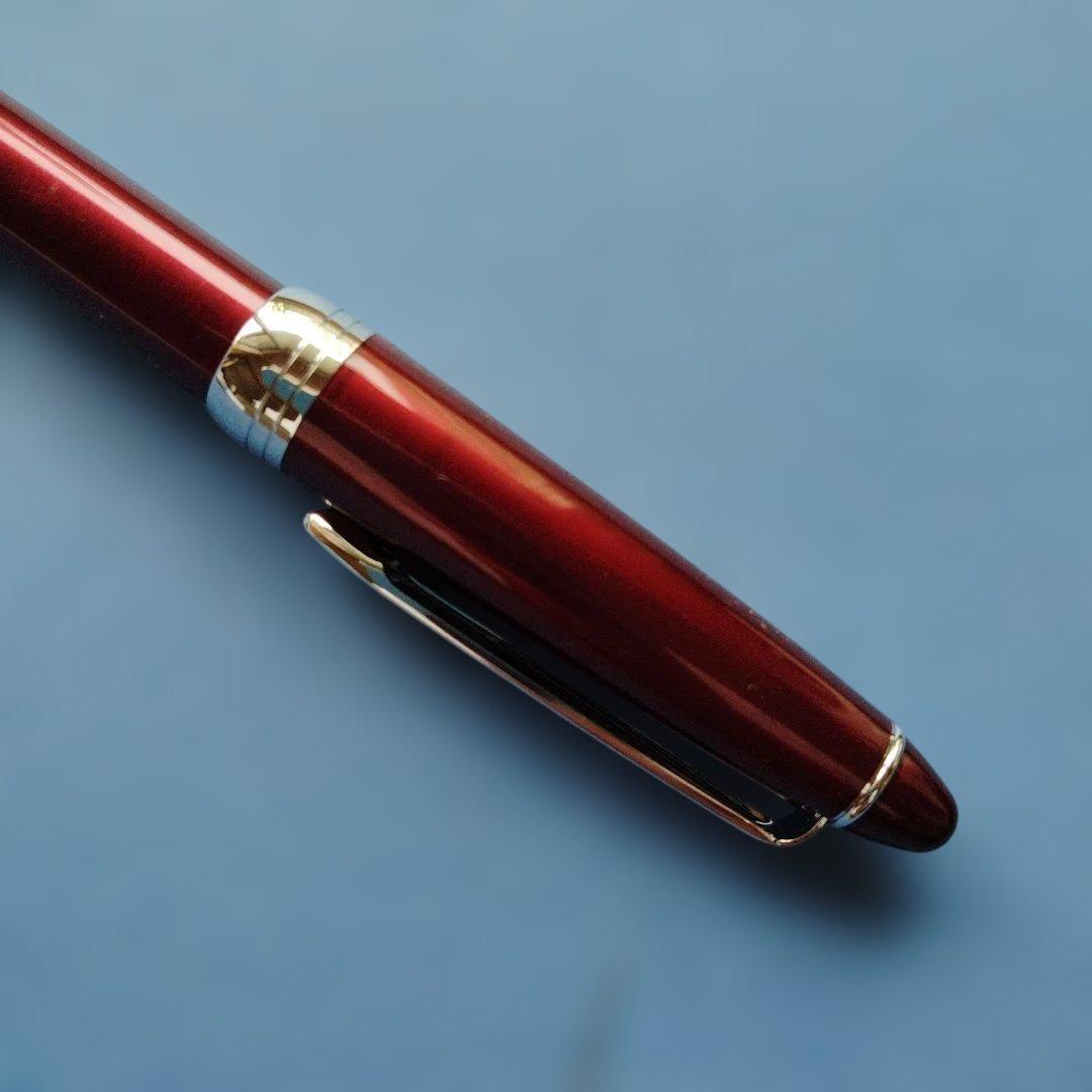 DAKS red ballpoint pen with silver clip and cap on white background metal body Japanese import
