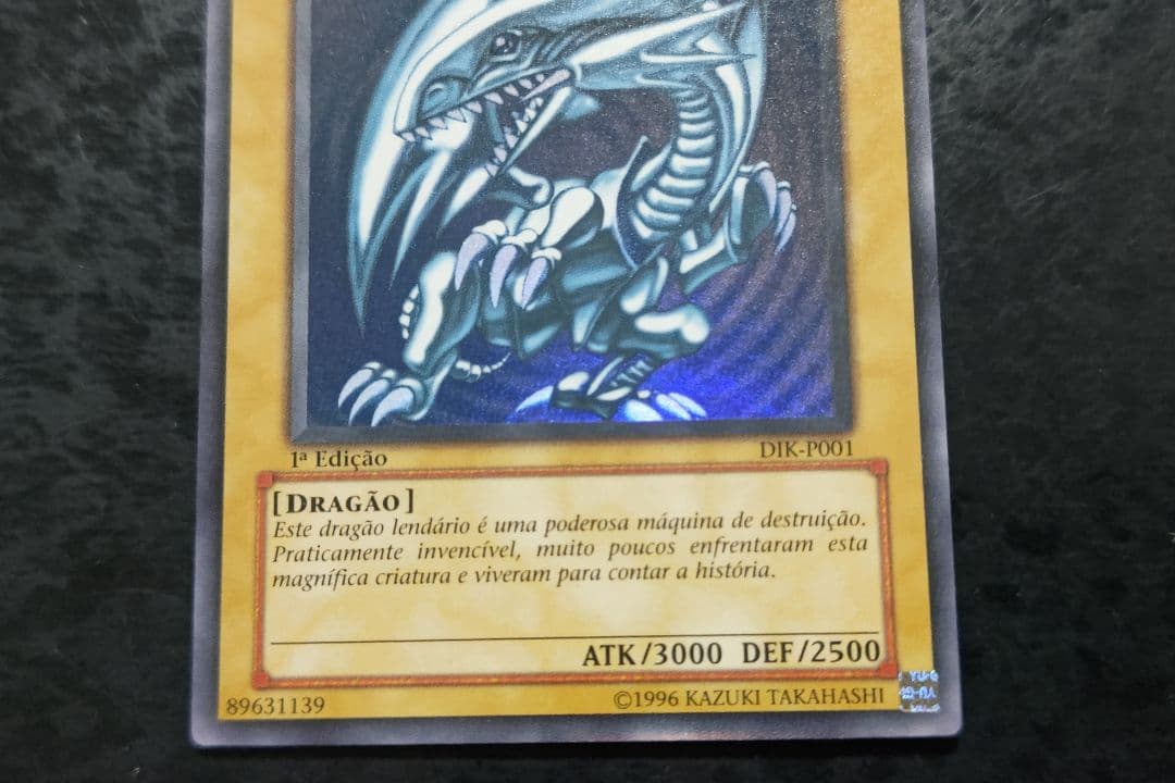 Portuguese Blue-Eyes White Dragon Ultra Rare Yu-Gi-Oh! card with minor scratches on front and back