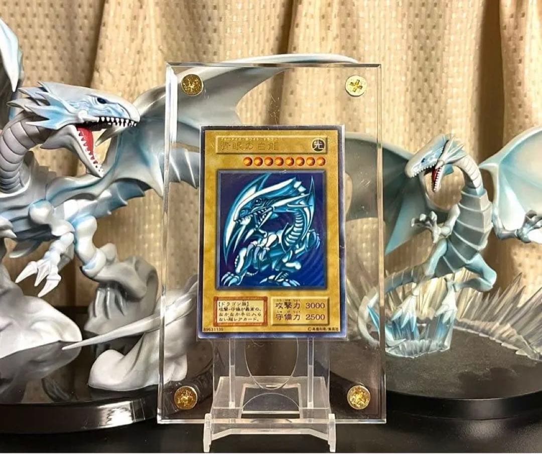 Yu-Gi-Oh Blue-Eyes White Dragon Initial Ultra Rare card in screw-down case with metallic border and slight scratches
