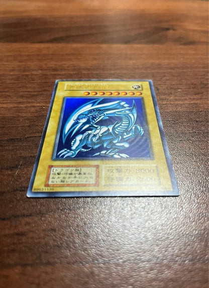 Yu-Gi-Oh Blue-Eyes White Dragon Initial Ultra Rare card in screw-down case with metallic border and slight scratches