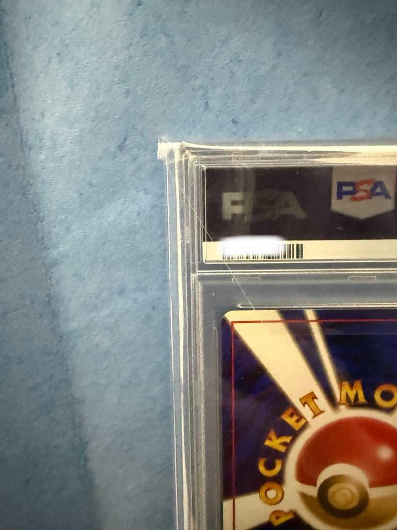 Bandai Rocket-dan Pokémon card with PSA 9 grade and old back design in protective case