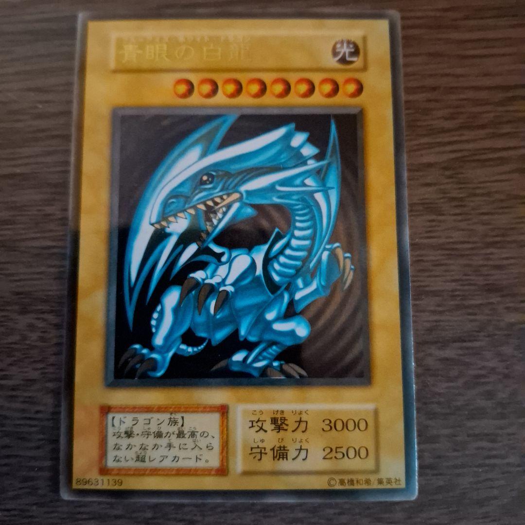 Bandai Blue-Eyes White Dragon stainless steel card holder with unopened loader showing Ultra Rare monster card
