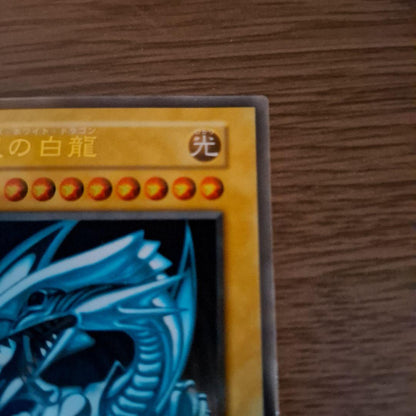 Bandai Blue-Eyes White Dragon stainless steel card holder with unopened loader showing Ultra Rare monster card