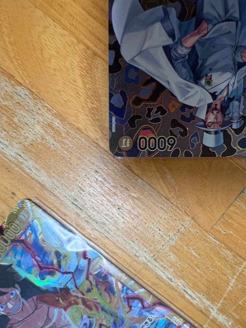 One Piece Card Game Rob Lucci SP OP05-093 rare card stored in a sleeve and folder with visible marks