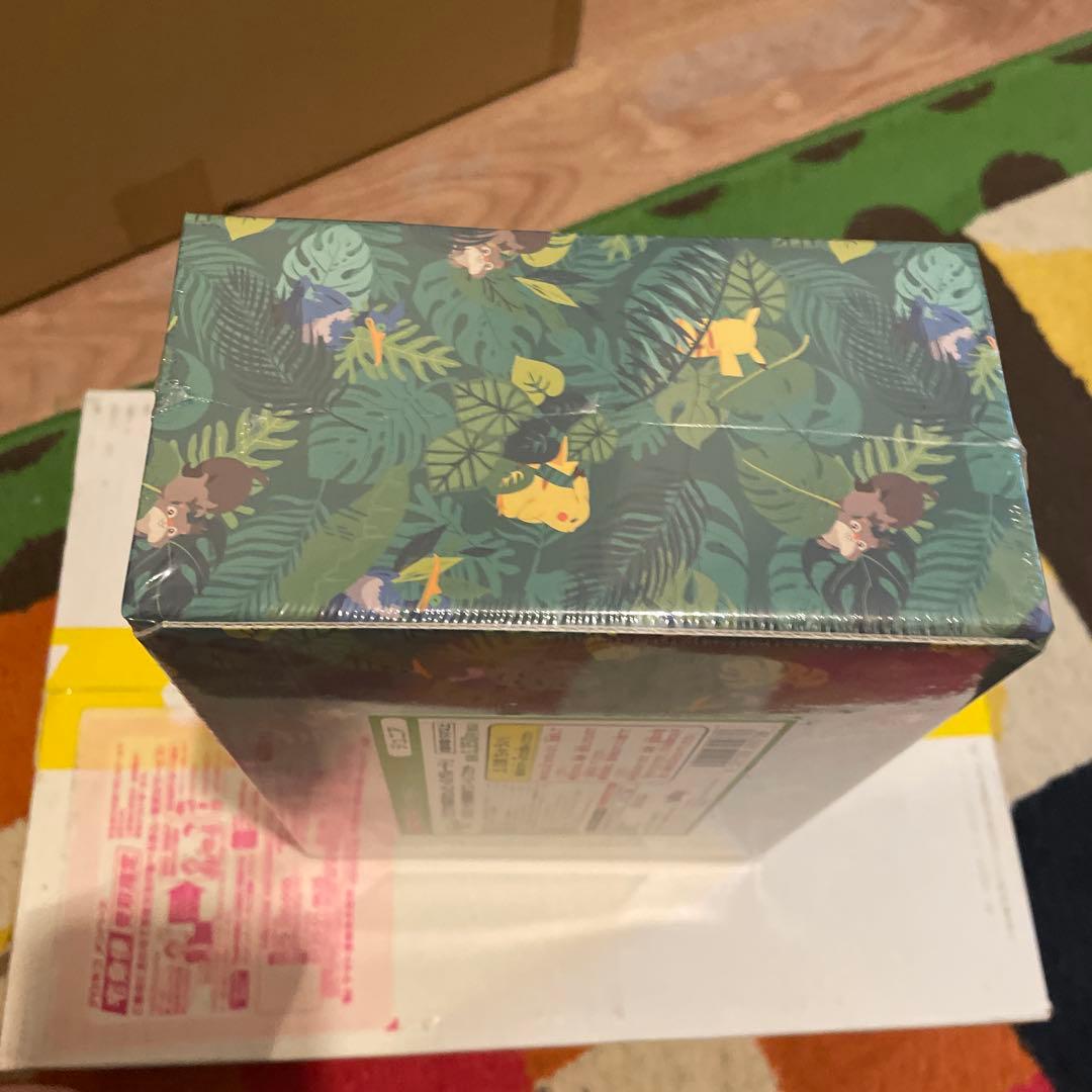 Bandai Pokemon Okoaya Forest Celebi & Zarude 7-Eleven set featuring promo cards, coins, booster packs, and serial code ticket