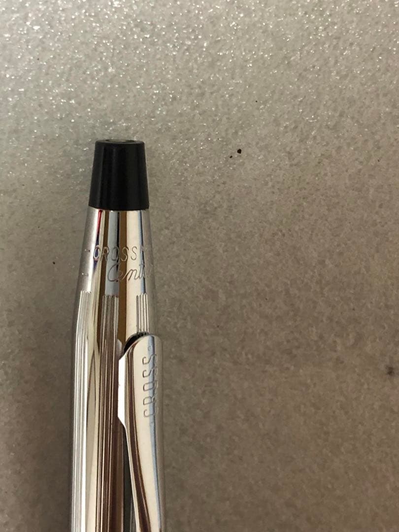 Cross brand sleek black pen with silver accents on a white background