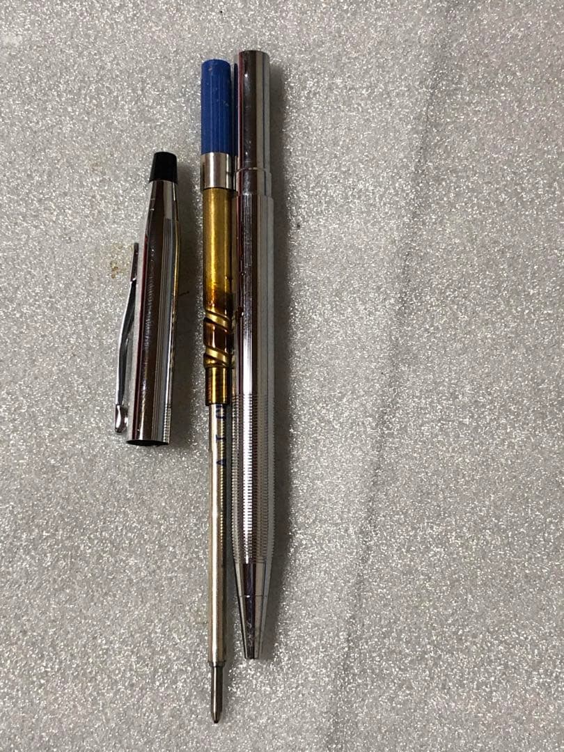 Cross brand sleek black pen with silver accents on a white background