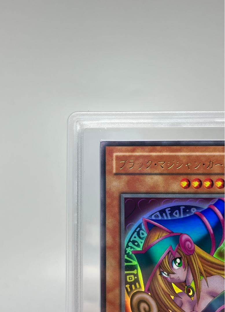 Yugioh Black Magician Girl Ultra Rare P4-01 trading card in protective sleeve with cardboard backing