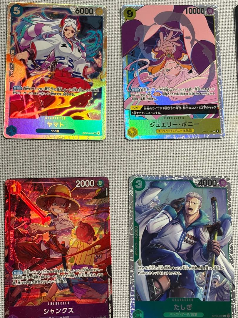 One Piece Card Game 13-card set featuring Monkey D. Luffy SEC and SR cards in protective sleeves