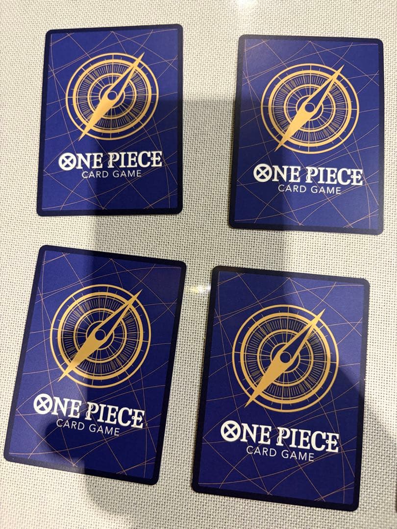 One Piece Card Game 13-card set featuring Monkey D. Luffy SEC and SR cards in protective sleeves