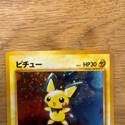 Old back Thunder Pikachu Pokemon card with spiral holo effect in protective sleeve showing slight wear
