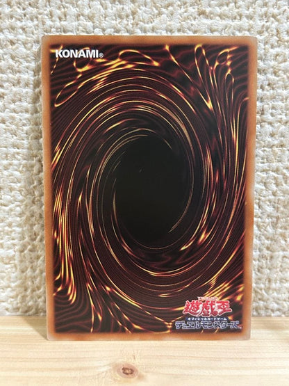 Chaos Origins Token displayed in protective sleeve on a plain surface