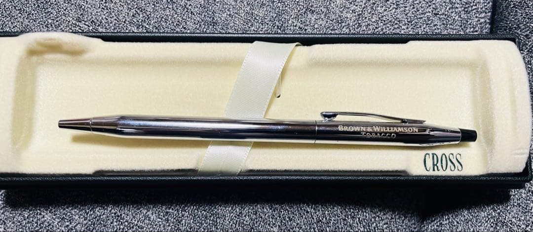 Cross silver ballpoint pen displayed with its dedicated case on a white background
