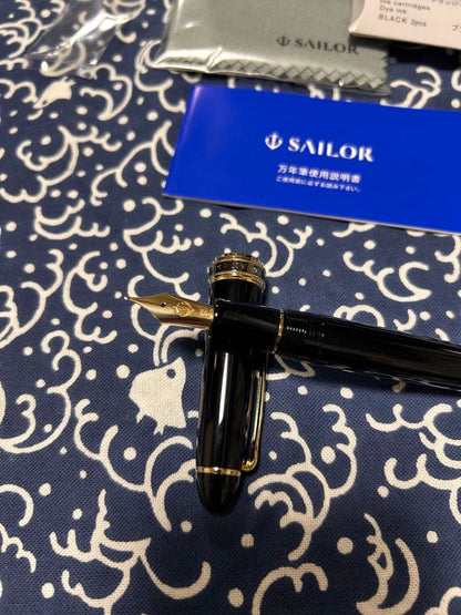 Sailor NMF fountain pen with medium fine 21K gold nib and black trim, shown with cap on