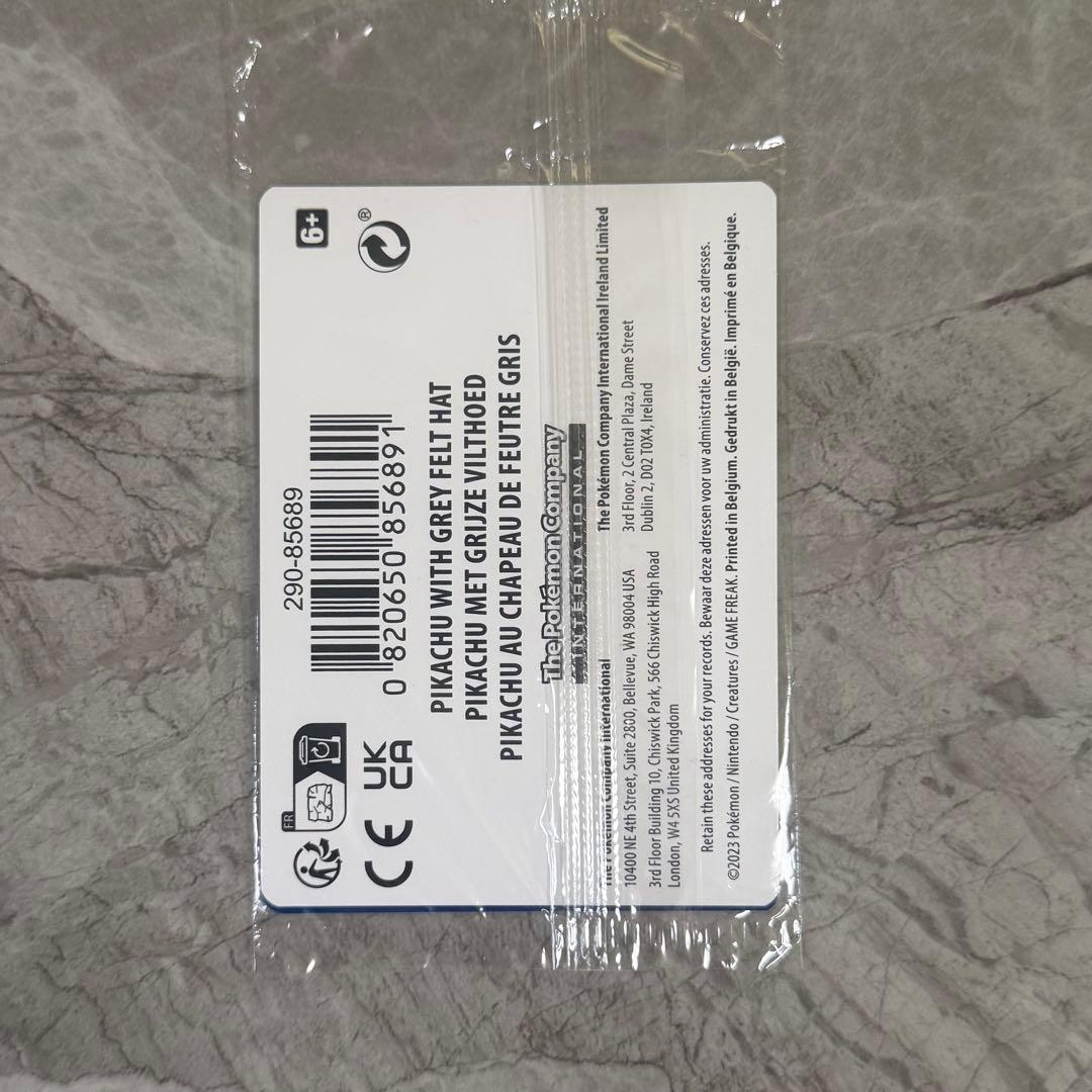Unopened Gogh Pikachu figure wearing grey felt hat with minor white scratch on lower left side