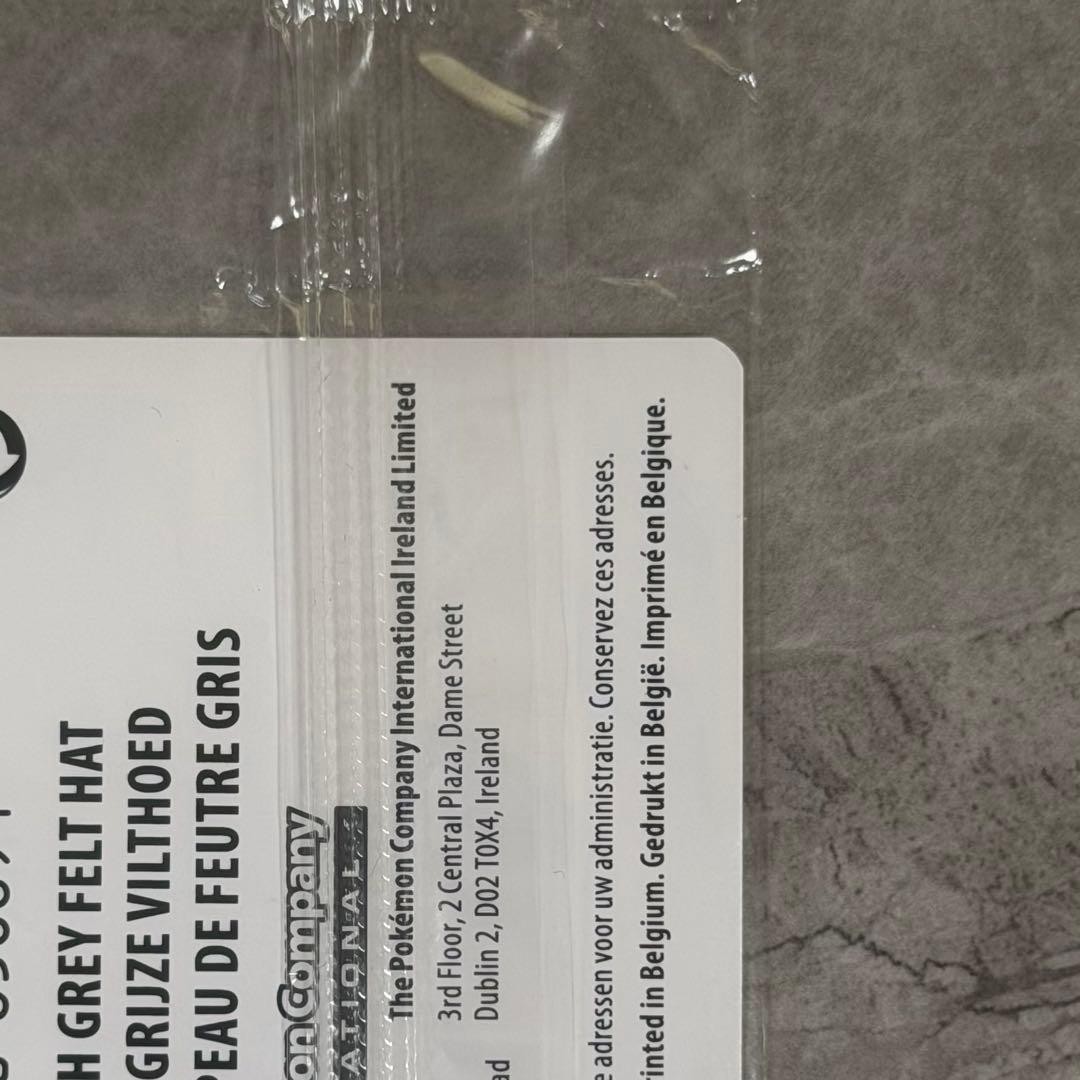 Unopened Gogh Pikachu figure wearing grey felt hat with minor white scratch on lower left side