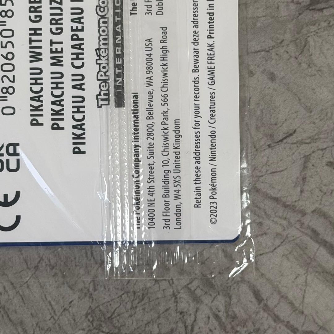 Unopened Gogh Pikachu figure wearing grey felt hat with minor white scratch on lower left side