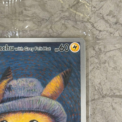 Unopened Gogh Pikachu figure wearing grey felt hat with minor white scratch on lower left side