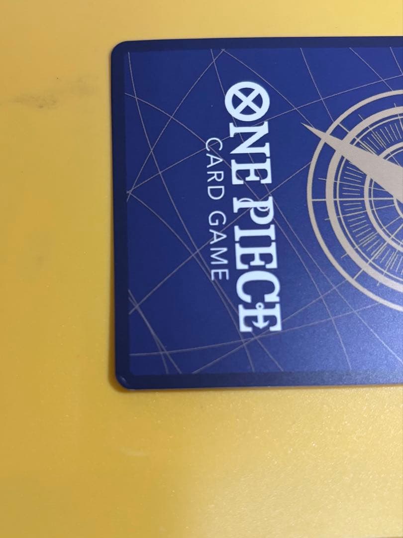 One Piece Portgas D. Ace OP13-119 trading card with slight white specks and fold at lower right edge