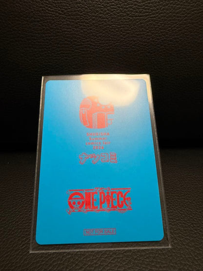 One Piece Natsucomi 2026 Metakira card featuring Monkey D. Luffy signed by Eiichiro Oda in protective sleeve