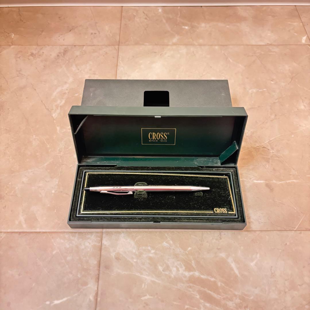 Cross silver ballpoint pen with a slim design displayed next to its matching protective case