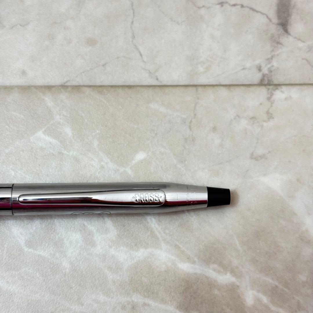 Cross silver ballpoint pen with a slim design displayed next to its matching protective case