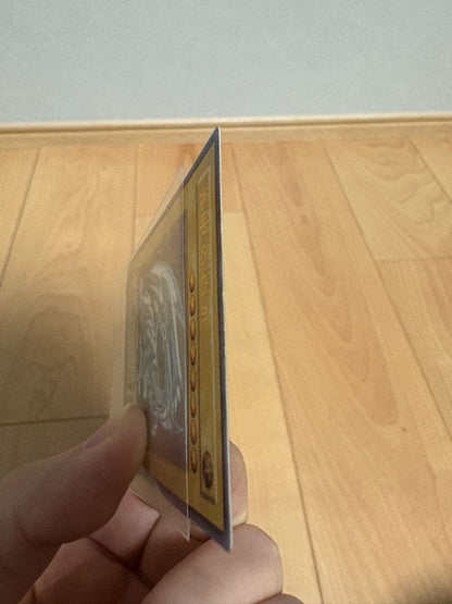 Blue-Eyes White Dragon Relief Card SM-51 with visible wear and a small white chip, Japanese Yu-Gi-Oh collectible
