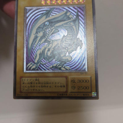 Blue-Eyes White Dragon Ultra Rare card collectible with 3000 attack, 2500 defense, chipped top and back, clean blue body