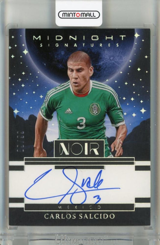2025-26 Panini Noir Carlos Salcido Midnight Signatures Auto trading card serial number 2189 of 99 with visible initial scratch