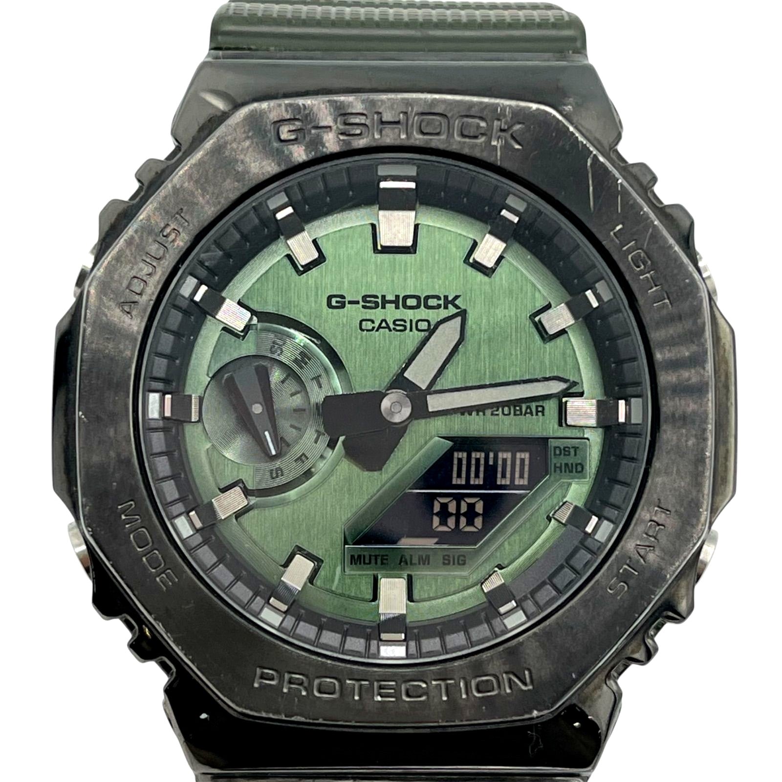 Casio G-Shock GM-2100DB watch with green dial, metal bezel, and analog-digital display