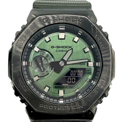 Casio G-Shock GM-2100DB watch with green dial, metal bezel, and analog-digital display