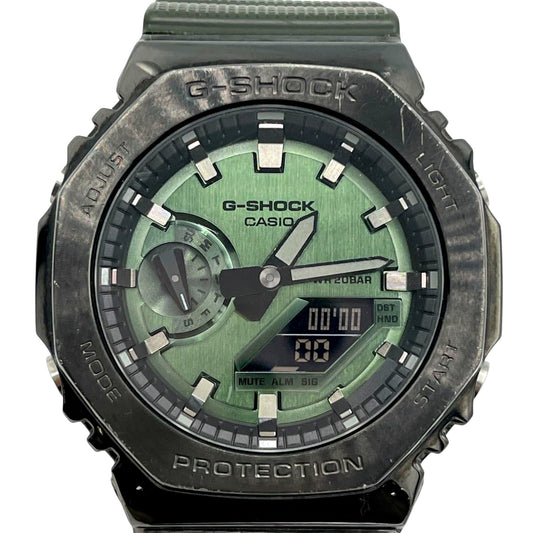 Casio G-Shock GM-2100DB watch with green dial, metal bezel, and analog-digital display