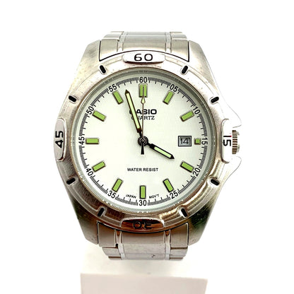 Casio MTP-1244 quartz watch with white dial and stainless steel case showing water resistance feature
