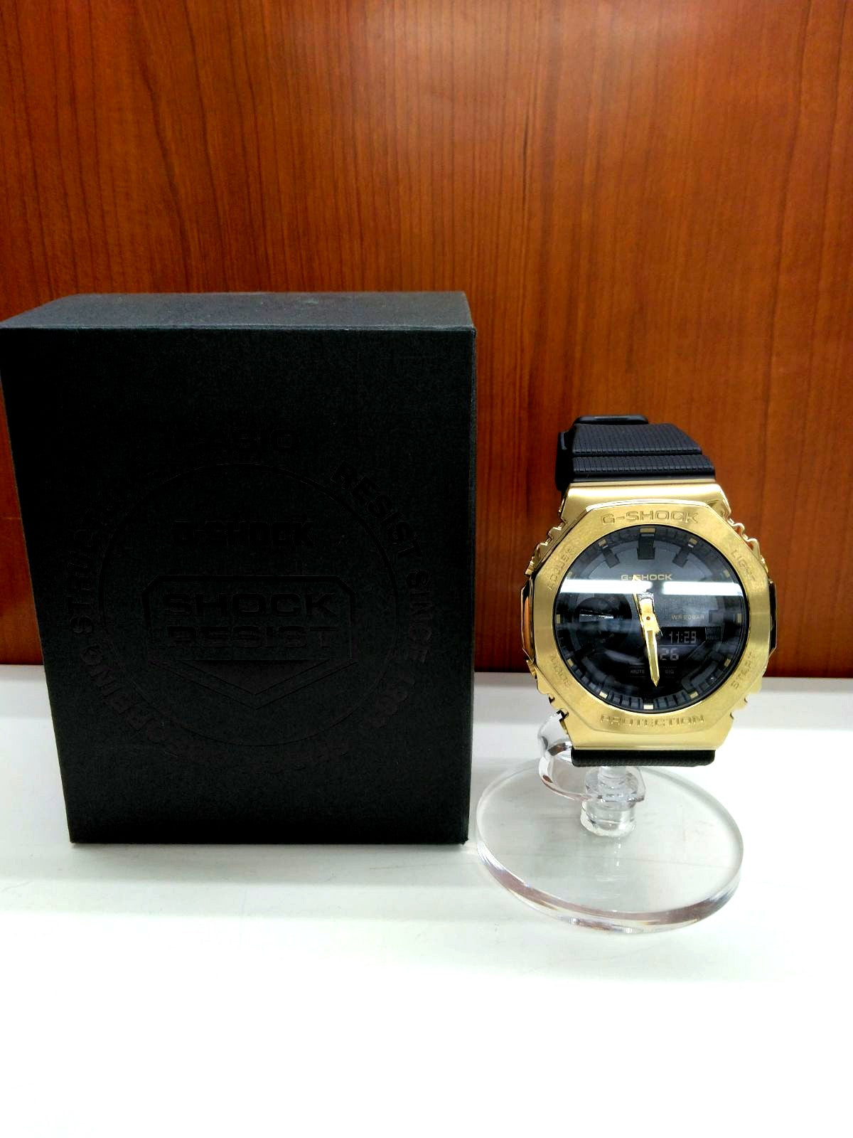 Casio G-Shock GM-2100G-1A9JF wristwatch with black and gold-tone finish in used condition