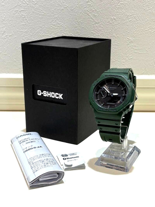 Casio G-Shock GA-B2100 solar analogue-digital watch with green resin band and slight bend on band